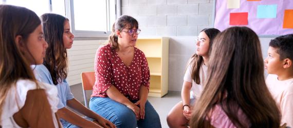 a group of people sitting and looking at the camera