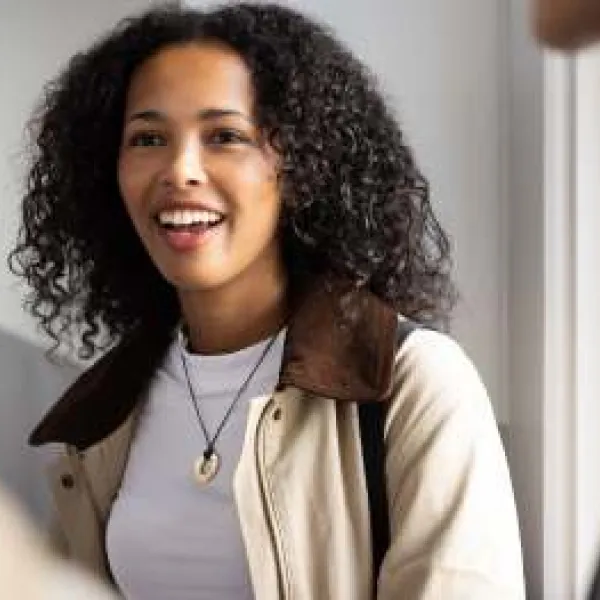 a learner smiling in a room