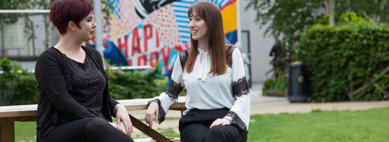 a couple of people that are standing in the grass