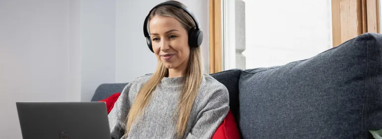 a man wearing glasses and smiling at the camera