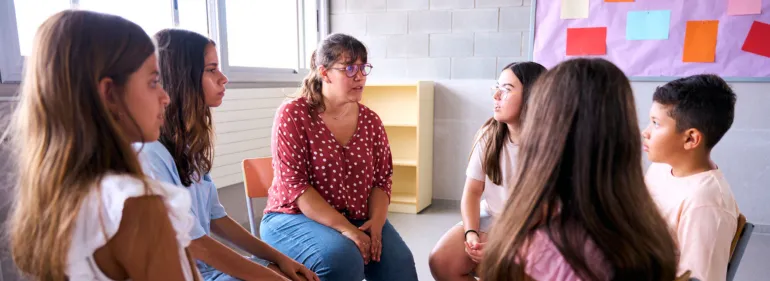 a group of people sitting and looking at the camera