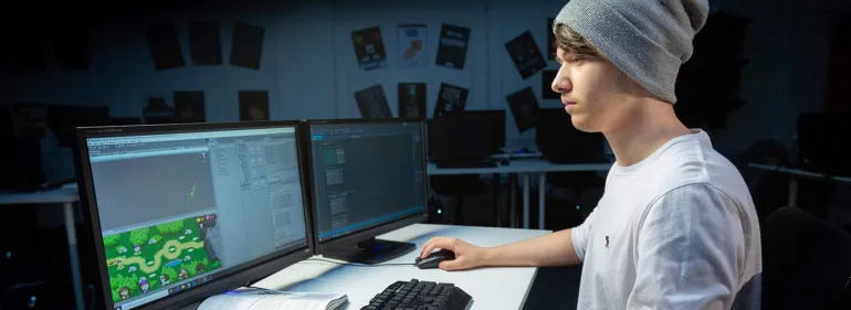 a man standing in front of a computer