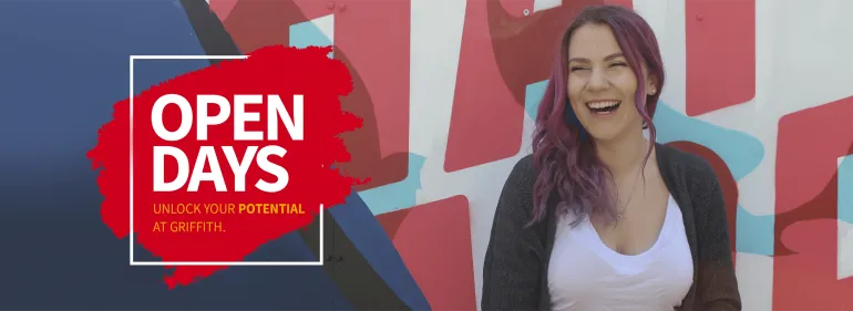 a woman holding a sign posing for the camera