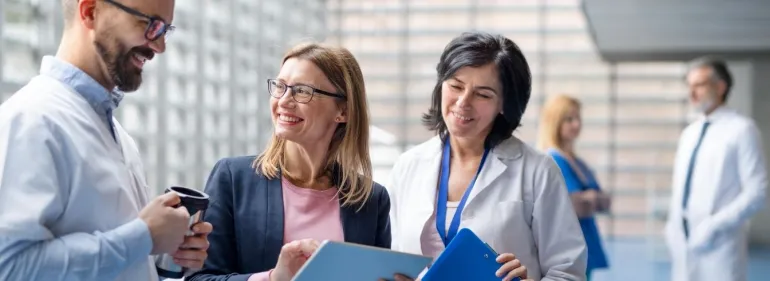 Three doctors discussing pharmaceutical sales