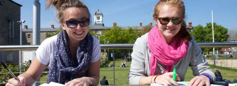 a man and a woman sitting on a sunny day