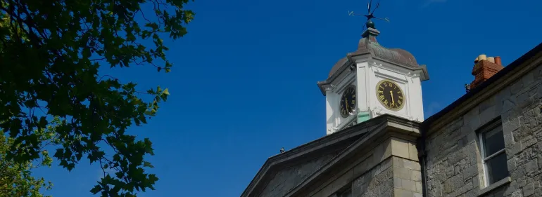 a large tall tower with a clock on the side of a building