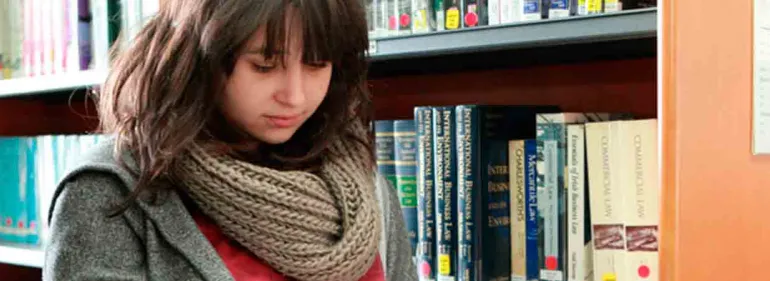 a woman holding a book shelf