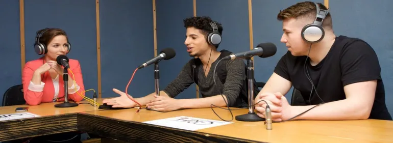 a group of people sitting at a table with a laptop