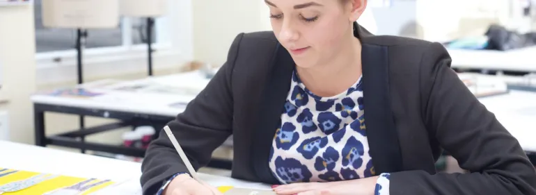 female student working on fashion portfolio