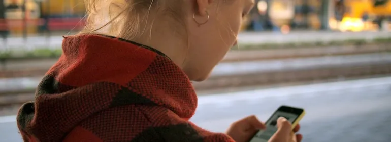 Young woman looking at her phone screen