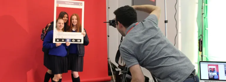 Students visit a Griffith College open day and pose with an Instagram frame while their photo is taken