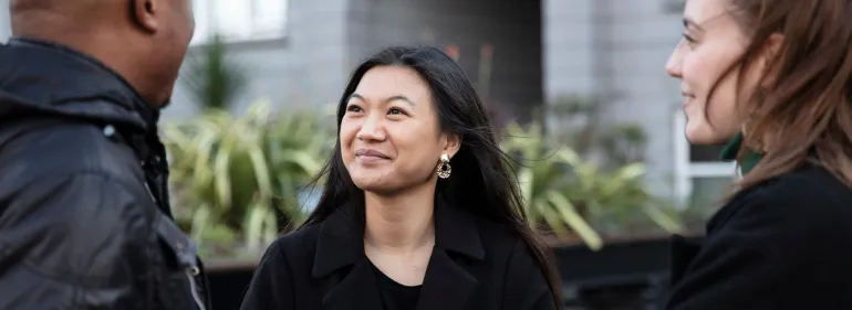 Students smiling outside Griffith Halls of Residence