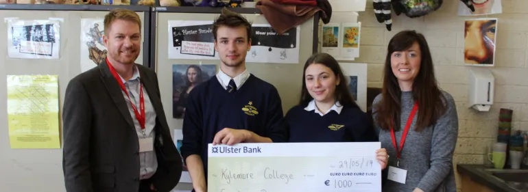 Griffith College Schools Liaison Officer presents a bursary check to students at Kylemore College