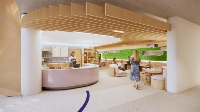 Pictured is a café with a counter and seating, filled with people. There are beams on the ceiling and a moss installation, as well as bespoke lighting. 