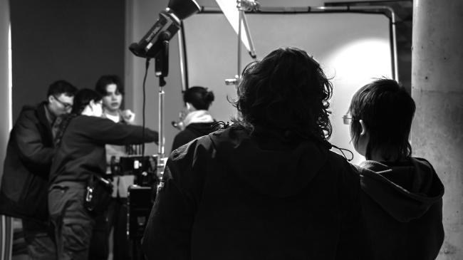a couple of people that are standing in front of a mirror