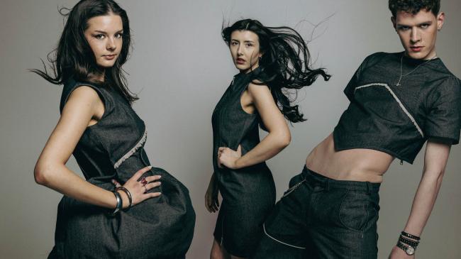Three models showing close-up of clothing design details in black denim fabric.