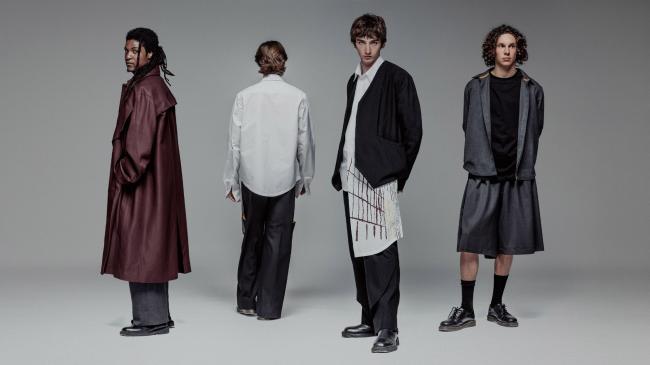 a person standing in front of a group of people posing for the camera
