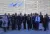 a group of people standing in front of a crowd posing for the camera