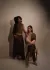 Two models, one sitting and one standing 