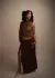Model wearing matching quilted shawl and wrap skirt, standing