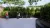 This image shows a small family spending time in a small rooftop garden, with surrounded by bushes and trees. 