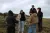 a group of people standing in a field