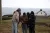 a group of people standing next to a body of water