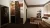 Double bedroom with layered lighting - LED lamps and overhead fixtures, thick curtains, wooden bed frame and headboard, inset open wardrobe, and a desk area featuring a Marshall amplifier and vinyl record player.