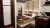 Double bedroom from another angle, showing layered atmospheric lighting, warm curtains, wooden bed and headboard, inset open wardrobe, and a desk with a Marshall amplifier and vinyl record player.