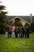 a group of people standing in front of a house