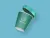 This coffee cup showcases the Cúpla Focal branding applied to takeaway packaging, displaying the recognisability of the logo across physical products. The muted green and blue palette represents the national colour of Ireland (blue) and the green earth of the country (green). The clean white logo maintains a modern and approachable aesthetic.