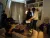 a group of people sitting around a living room