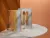 6-	2 journals are displayed on a white table in an orange lit room, the front and back cover of the journal are displayed showing interlocking puzzle piexes in a graident of orange and yellows with a shortened version of the Jigsaw logo.