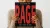 Person holding the book “RAGE” in front of their face, emphasizing bold cover design and concept. 