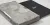 A black book titled "Fragments: Lisbon, 1755" next to its textured, concrete-like case with a translucent sleeve