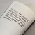 Close-up page from "Fragments: Lisbon, 1755", featuring a quote in black serif and sans-serif typography with dashed lines radiating towards a seismic epicentre