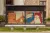 4 illustrated adverts of Pelomico on a bus stop 