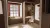 Guest bedroom corner with alcove, timber blinds, bespoke wardrobe, desk and chair.