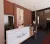 Hotel reception with marble front desk, timber wall panelling, artwork and guest interaction.