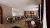 Hotel dining area with traditional seating, large windows, curtains and buffet counter.