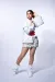 Zipped blouse jacket with a Krieger belt, sequined skirt and draped shoes 
