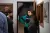 a man and a woman standing in front of a mirror