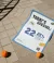 Marketing poster on pavement between two oranges, featuring bold text "TODAY'S SPECIAL: 22.25%" with "Junk Feed" branding in blue and yellow.