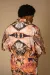 Male model wears floral jumpsuit with symmetric print