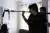 a man standing in front of a mirror posing for the camera