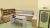 a bedroom with a bed and desk in a small room