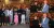 a group of people standing in front of a crowd posing for the camera