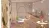 a room filled with furniture and vase of flowers on a table