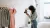 a woman standing in front of a mirror posing for the camera