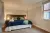 a bedroom with a bed in a room